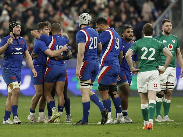 France's Thibaud Flament and Donovan Taofifenua celebrate with teammates after the match in February 2022
