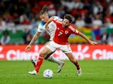 Joe Allen in action for Wales against England at the 2022 World Cup.