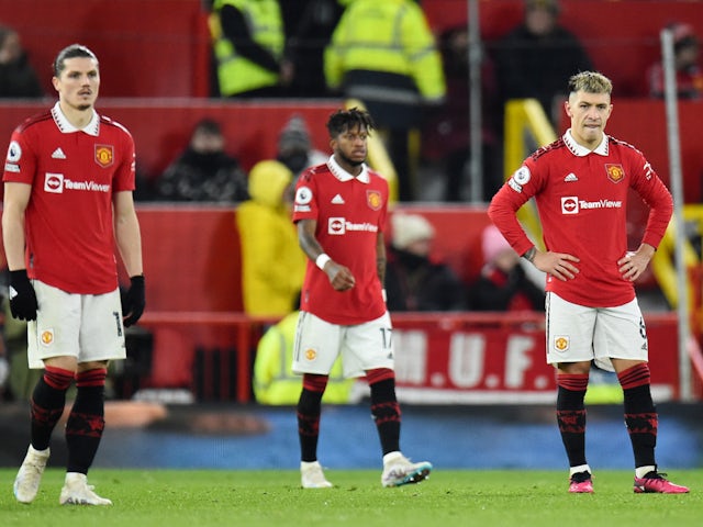 Manchester United players look dejected after Raphael Varane scores an own goal on February 8, 2023
