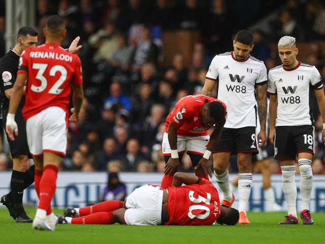 Nottingham Forest's Willy Boly reacts after sustaining an injury as players look on on February 11, 2023