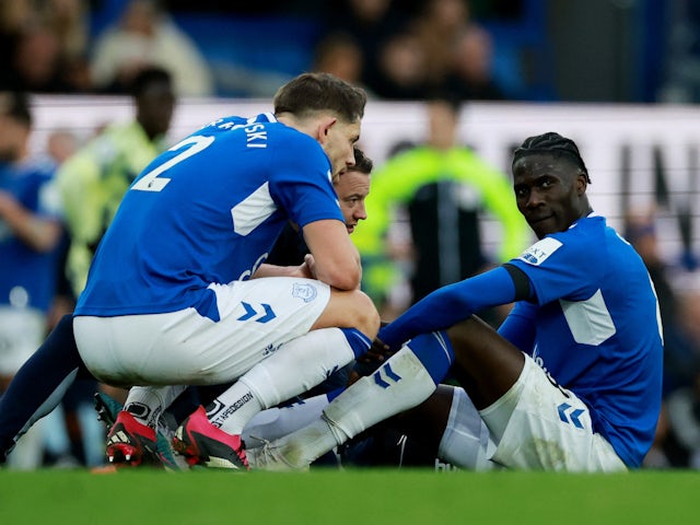 Everton's Amadou Onana reacts after sustaining an injury as James Tarkowski looks on on February 18, 2023