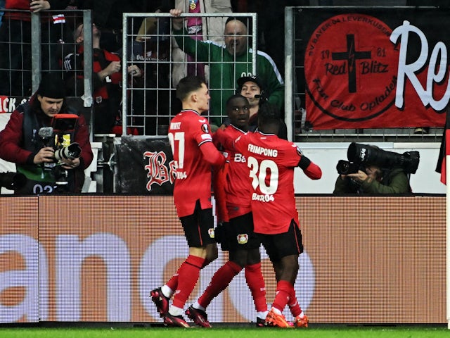 Bayer Leverkusen's Moussa Diaby celebrates scoring their first goal with Florian Wirtz and Jeremie Frimpong on February 16, 2023