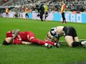 Liverpool's Darwin Nunez and Newcastle United's Kieran Trippier react after sustaining injuries from a challenge on February 18, 2023