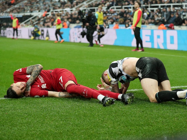 Liverpool's Darwin Nunez and Newcastle United's Kieran Trippier react after sustaining injuries from a challenge on February 18, 2023