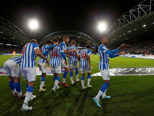 Huddersfield Town's Duane Holmes celebrates scoring their first goal with teammates on December 29, 2022