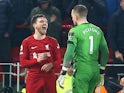 Liverpool's Andrew Robertson clashes with Everton's Jordan Pickford on February 13, 2023