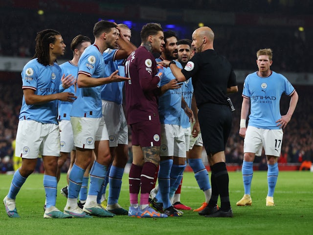 Manchester City players remonstrate with referee Anthony Taylor on February 15, 2023