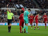 Newcastle United's Nick Pope is shown a red card by referee Anthony Taylor for handling the ball outside the area on February 18, 2023
