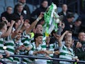 Celtic's Callum McGregor lifts the trophy alongside teammates as they celebrate after winning the Scottish League Cup on February 26, 2023