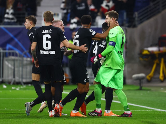 Eintracht Frankfurt's Kevin Trapp celebrates saving a penalty from Napoli's Khvicha Kvaratskhelia with teammates on February 21, 2023