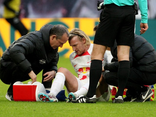 RB Leipzig's Emil Forsberg receives medical attention after sustaining an injury on February 25, 2023