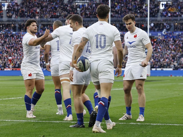 France's Romain Ntamack celebrates scoring their first try with teammates on February 26, 2023