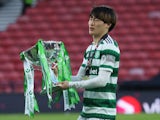 Celtic's Kyogo Furuhashi celebrates with the trophy after winning the Scottish League Cup on February 26, 2023