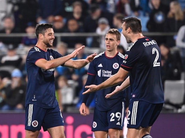New England Revolution midfielder Matt Polster (8) and midfielder Noel Buck (29) and defender Dave Romney (2) celebrate after the game at Bank of America Stadium on February 25, 2023