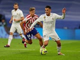 Real Madrid's Dani Ceballos in action with Atletico Madrid's Marcos Llorente on February 25, 2023