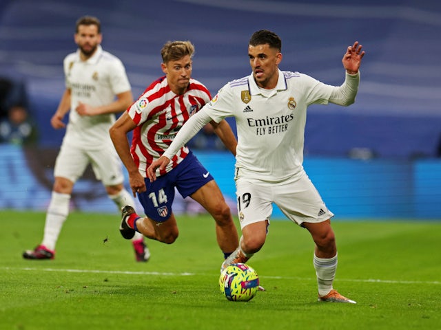 Real Madrid's Dani Ceballos in action with Atletico Madrid's Marcos Llorente on February 25, 2023
