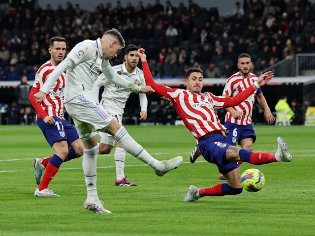 Real Madrid's Federico Valverde in action with Atletico Madrid's Jose Gimenez on February 25, 2023