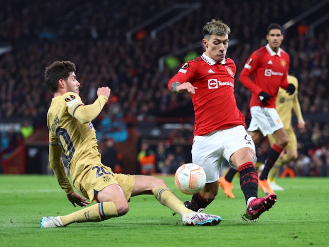 Barcelona's Sergi Roberto in action with Manchester United's Lisandro Martinez on February 23, 2023