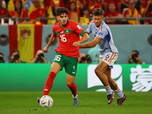 Morocco's Abde Ezzalzouli in action with Spain's Marcos Llorente on December 6, 2022