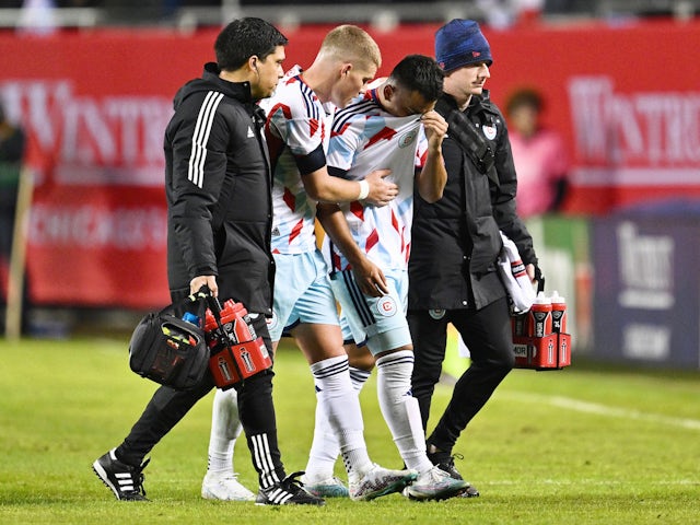Chicago Fire FC forward Jairo Torres (20) is helped off the pitch by trainers and forward Chris Mueller (8) after being injured in the second half against New York City FC at Soldier Field on March 4, 2023