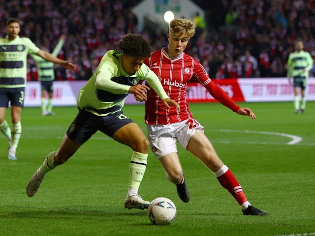 Manchester City's Rico Lewis in action with Bristol City's Sam Bell on February 28, 2023