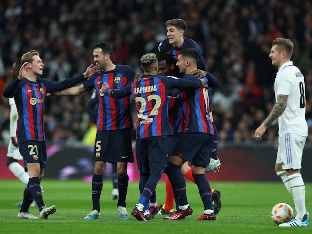 Barcelona players celebrate an own goal from Real Madrid defender Eder Militao on March 2, 2023