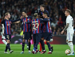 Barcelona players celebrate an own goal from Real Madrid defender Eder Militao on March 2, 2023