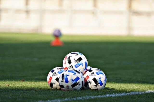 football balls on pitch and white line