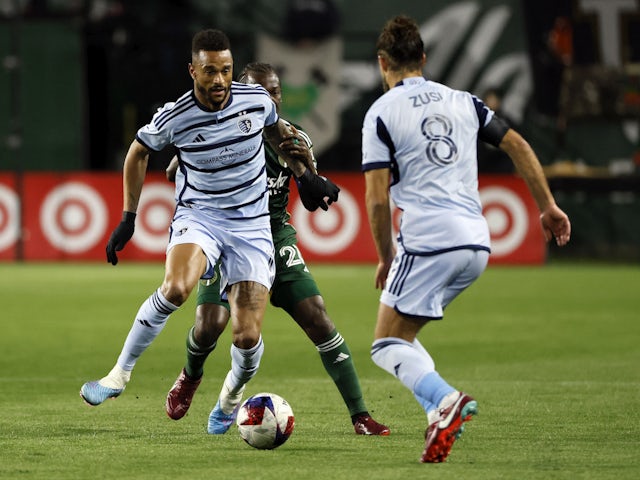 Sporting Kansas City midfielder Roger Espinoza (15) battles for the ball with Portland Timbers midfielder Diego Chara (21, behind) during the first half at Providence Park on February 28, 2023