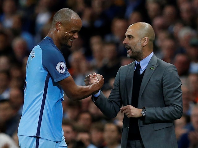 Manchester City's Vincent Kompany pictured with manager Pep Guardiola on May 16, 2017