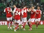 Arsenal players celebrate an own goal scored by Sporting Lisbon's Hidemasa Morita on March 9, 2023