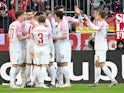 Augsburg's Mergim Berisha celebrates scoring their first goal with teammates on March 11, 2023