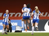 Brighton & Hove Albion Women's Elisabeth Terland celebrates scoring their first goal with Lee Geum-min on March 12, 2023