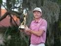 Cameron Smith displays the champions trophy after winning The Players Championship golf tournament at TPC Sawgrass on March 14, 2022