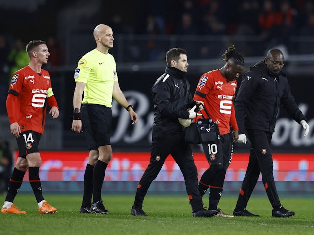 Stade Rennes' Jeremy Doku walks off the pitch to be substituted after sustaining an injury as referee Eric Wattellier and Benjamin Bourigeaud look on on March 5, 2023