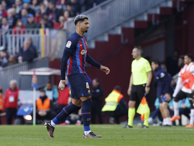 Barcelona's Ronald Araujo walks off the pitch after receiving a red card by referee Javier Alberola Rojas on March 5, 2023