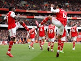 Bukayo Saka celebrates scoring for Arsenal with Gabriel Magalhaes on March 19, 2023