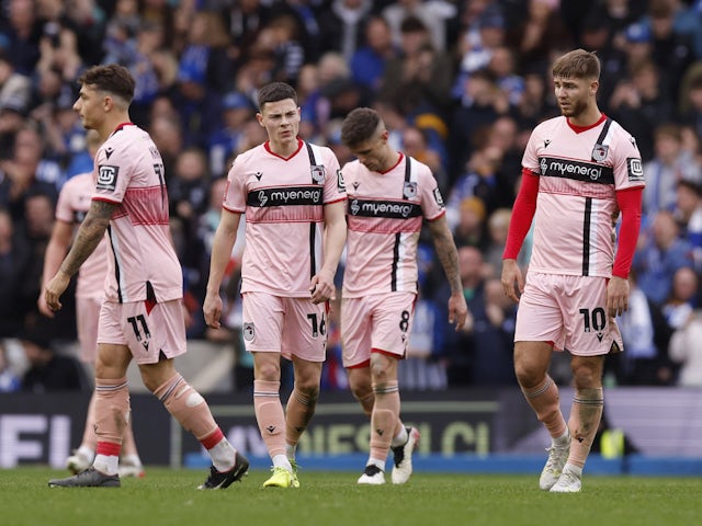 Grimsby Town's John Mcatee, Alex Hunt and teammates look dejected after conceding their third goal on March 19, 2023