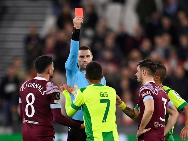 AEK Larnaca's Gus Ledes is shown a red card by referee Georgi Kabakov after a VAR review on March 16, 2023