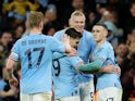 Manchester City's Erling Braut Haaland celebrates scoring their first goal with Julian Alvarez and Phil Foden on March 18, 2023