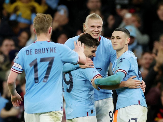 Manchester City's Erling Braut Haaland celebrates scoring their first goal with Julian Alvarez and Phil Foden on March 18, 2023