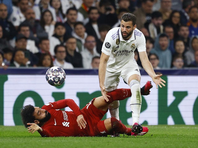 Liverpool's Mohamed Salah in action with Real Madrid's Nacho on March 15, 2023