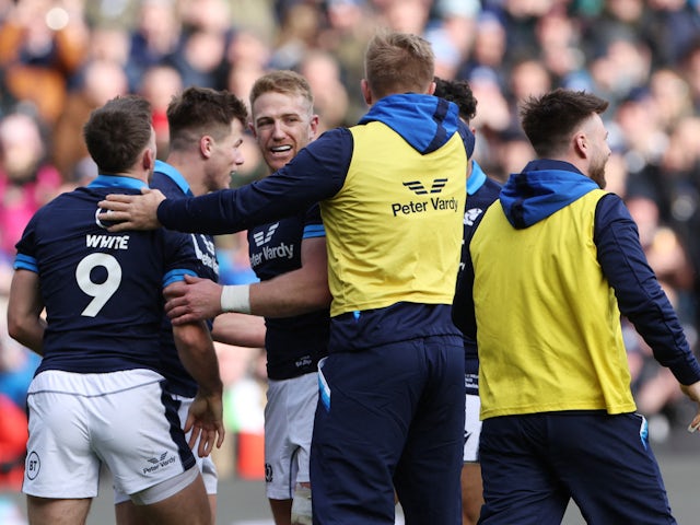 Scotland's Huw Jones celebrates scoring their first try with teammates on March 12, 2023