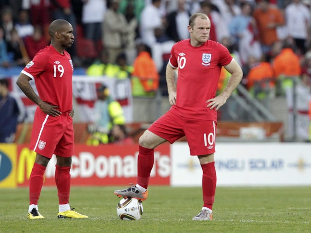 England's Wayne Rooney and Jermain Defoe react during a 2010 World Cup Group C soccer match against Slovenia in Port Elizabeth June 23, 2010