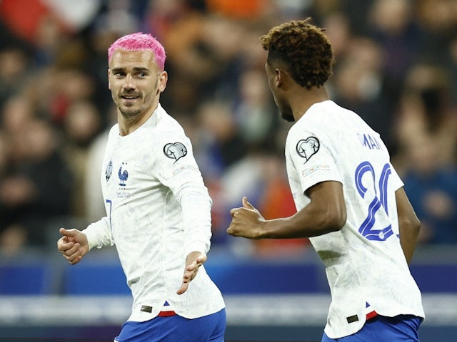France's Antoine Griezmann celebrates scoring their first goal with Kingsley Coman on March 24, 2023