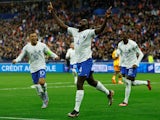 France's Dayot Upamecano celebrates scoring their second goal with Kylian Mbappe and Randal Kolo Muani on March 24, 2023