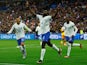 France's Dayot Upamecano celebrates scoring their second goal with Kylian Mbappe and Randal Kolo Muani on March 24, 2023