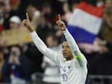 France's Kylian Mbappe celebrates scoring their third goal on March 24, 2023