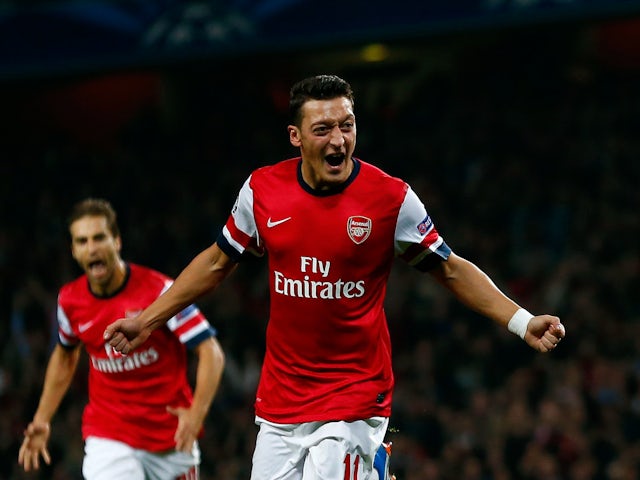 Mesut Ozil celebrates scoring for Arsenal against Napoli in October 2013