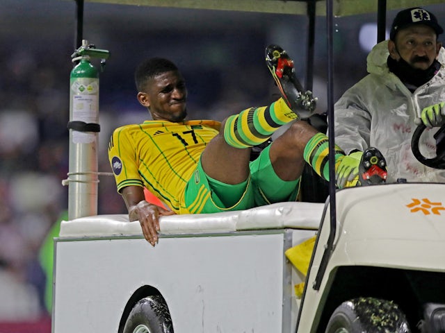 Jamaica's Damion Lowe is brought off the pitch after sustaining an injury on March 26, 2023
